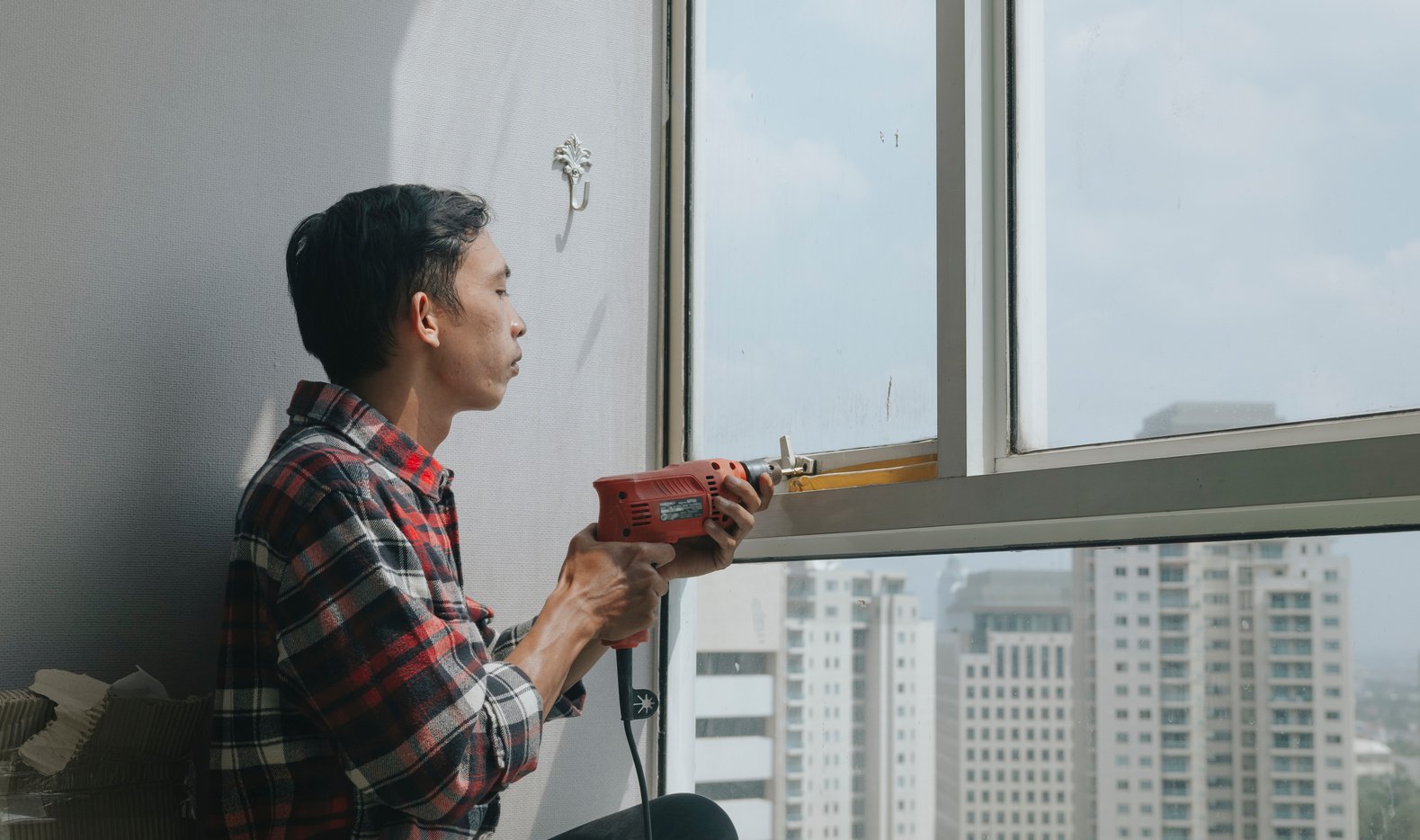 Handyman Repairing a Window Handle